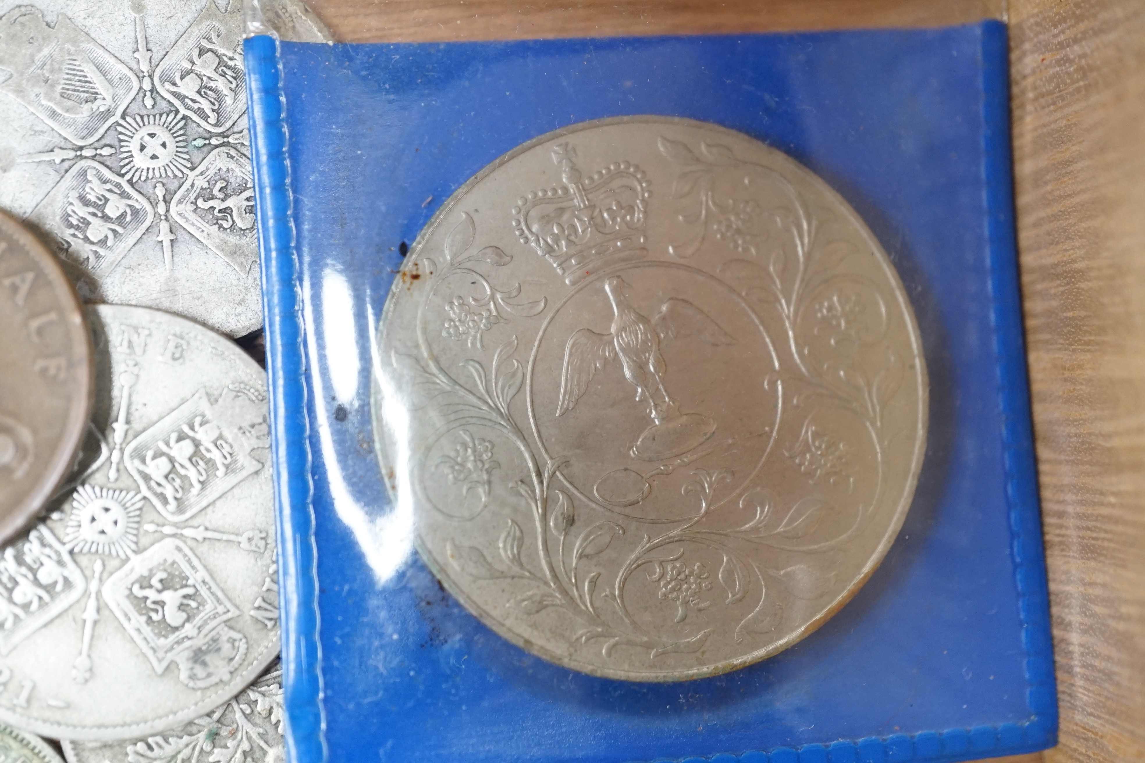 A collection of coins including a Victoria crown and two florins